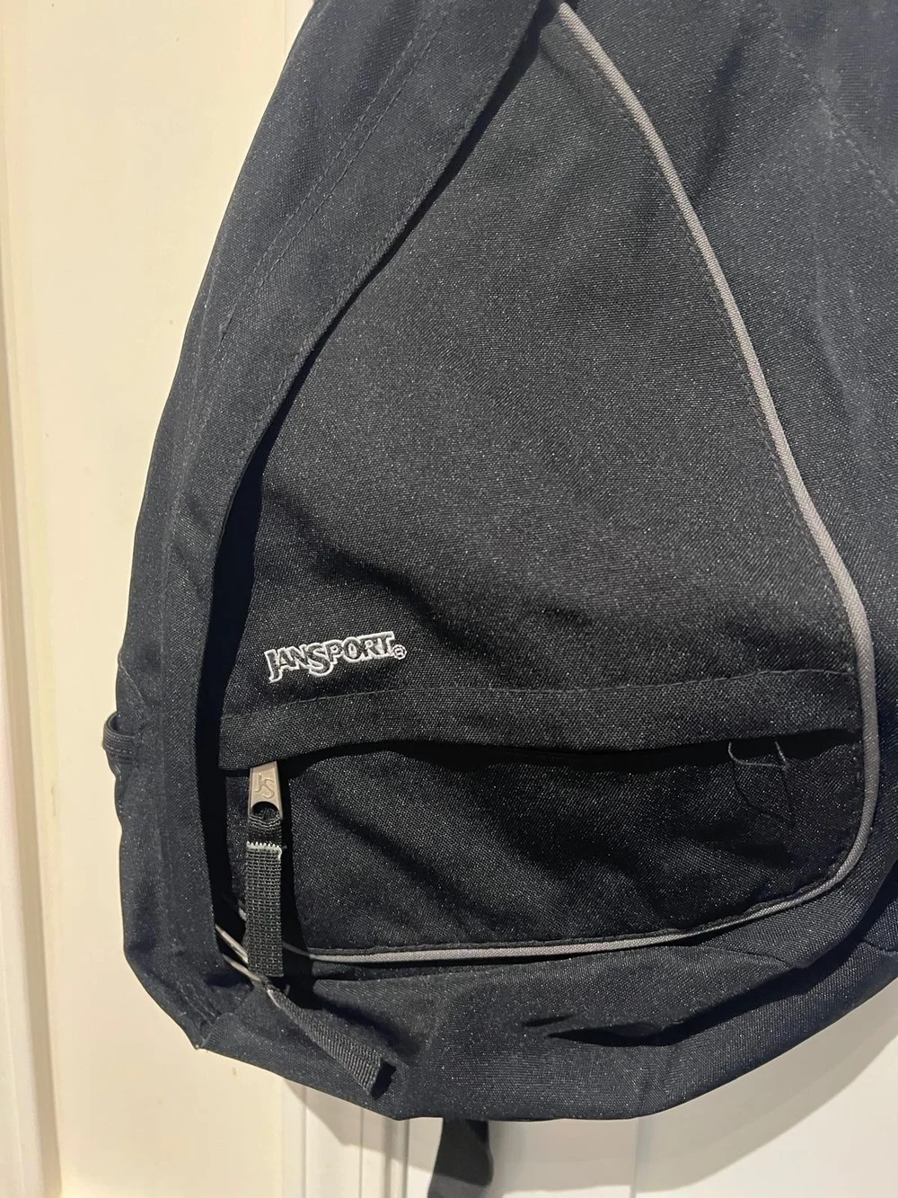 Jansport Black Sling Backpack with Front Zip Pocket